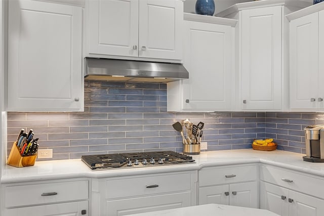 kitchen with ventilation hood, decorative backsplash, and white cabinetry