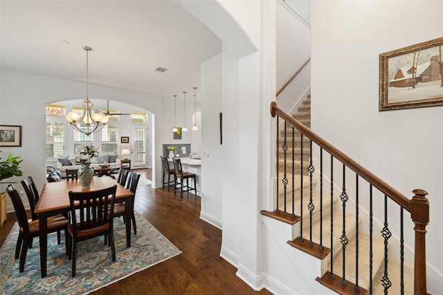 dining space featuring a notable chandelier and dark hardwood / wood-style flooring