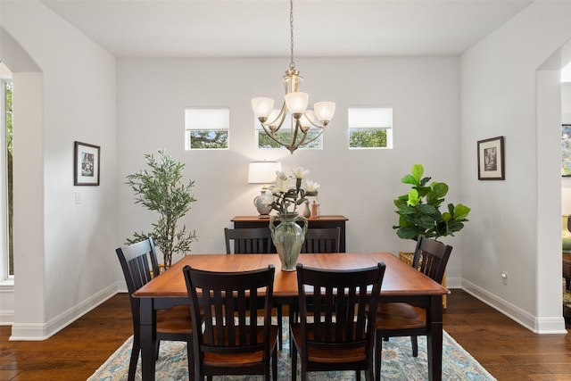 dining space featuring a notable chandelier and dark hardwood / wood-style floors