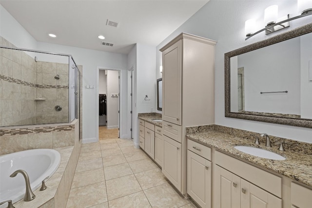 bathroom featuring tile patterned floors, vanity, and plus walk in shower