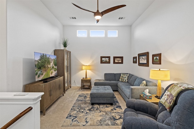 carpeted living room featuring ceiling fan