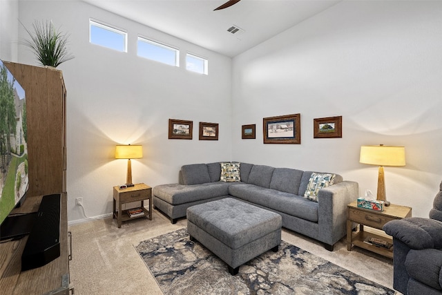 carpeted living room featuring ceiling fan