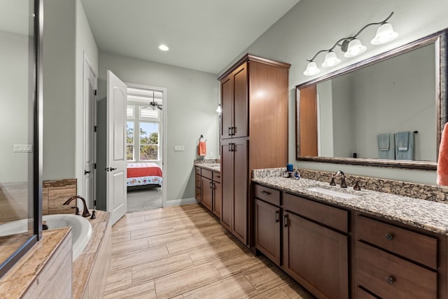 214 Darwins Way, Lakeway, TX 78734 - bathroom with vanity, a bath, ensuite bathroom, a ceiling fan, and recessed lighting