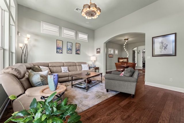 living room with a notable chandelier and dark hardwood / wood-style floors