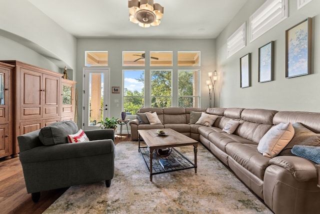 214 Darwins Way, Lakeway, TX 78734 - living room with wood finished floors, a chandelier, and a high ceiling