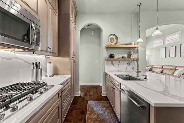 214 Darwins Way, Lakeway, TX 78734 - kitchen featuring stainless steel appliances, open shelves, dark wood-type flooring, arched walkways, and hanging light fixtures