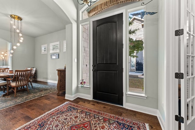 214 Darwins Way, Lakeway, TX 78734 - foyer entrance featuring arched walkways, dark wood-style flooring, and a chandelier