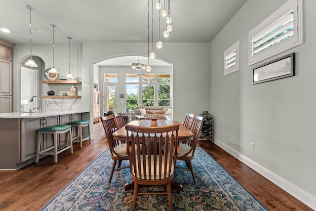 214 Darwins Way, Lakeway, TX 78734 - dining space featuring arched walkways, dark wood-style floors, a chandelier, and recessed lighting