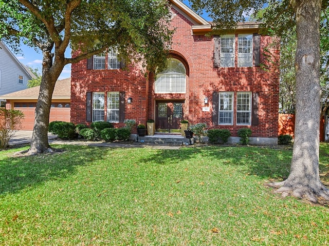 view of front of property with a garage and a front yard