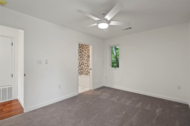 carpeted spare room with ceiling fan