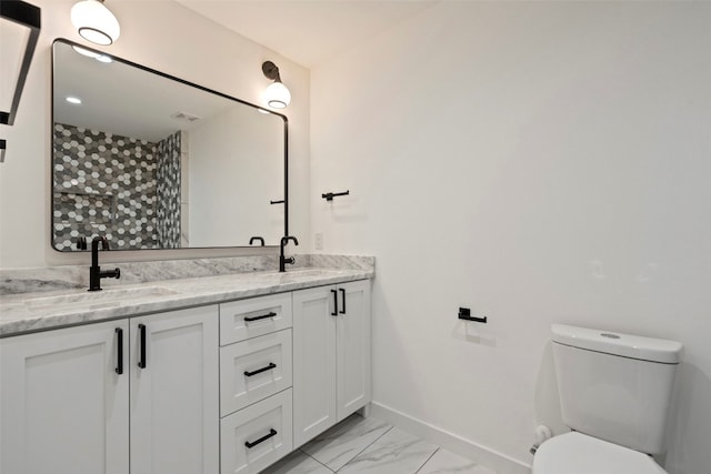 bathroom with vanity, a shower, and toilet