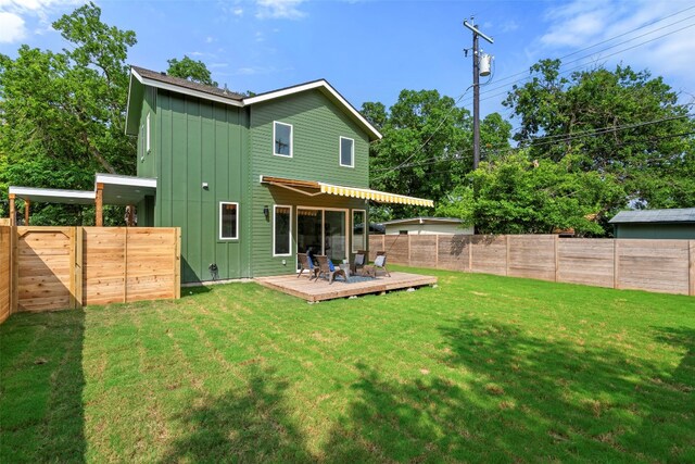 back of house with a yard and a wooden deck