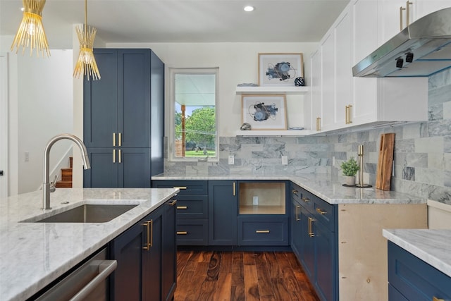 kitchen with pendant lighting, sink, light stone countertops, dark hardwood / wood-style floors, and stainless steel dishwasher