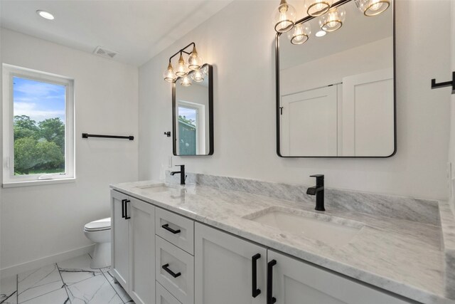 bathroom featuring vanity and toilet