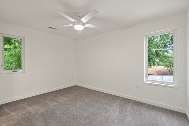 unfurnished room featuring ceiling fan and carpet floors