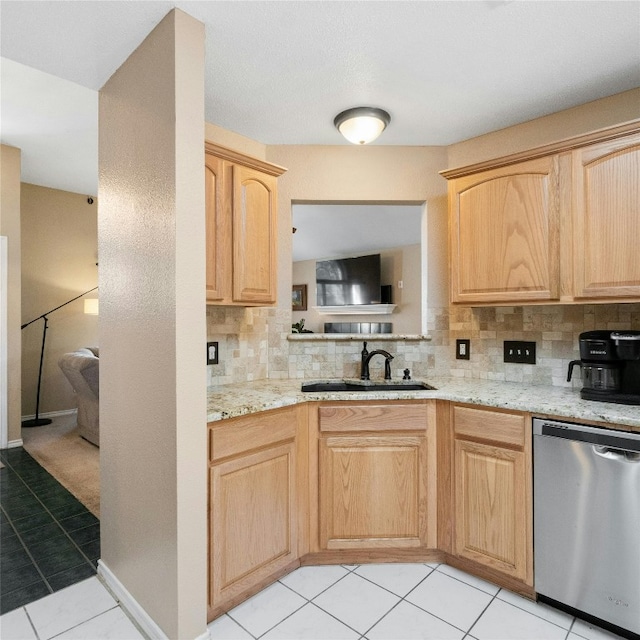 kitchen featuring light brown cabinetry, light tile patterned floors, decorative backsplash, and stainless steel dishwasher