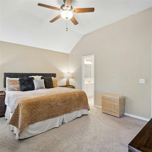 bedroom featuring ceiling fan, lofted ceiling, light carpet, and ensuite bathroom