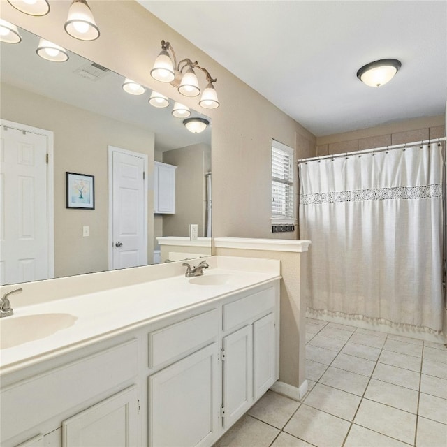 bathroom with curtained shower, tile patterned floors, and vanity