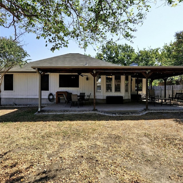 back of property with a yard and a patio area