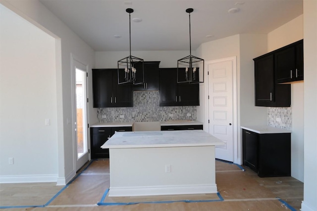 kitchen featuring pendant lighting, backsplash, plenty of natural light, and a kitchen island