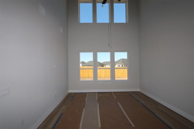 spare room featuring a towering ceiling