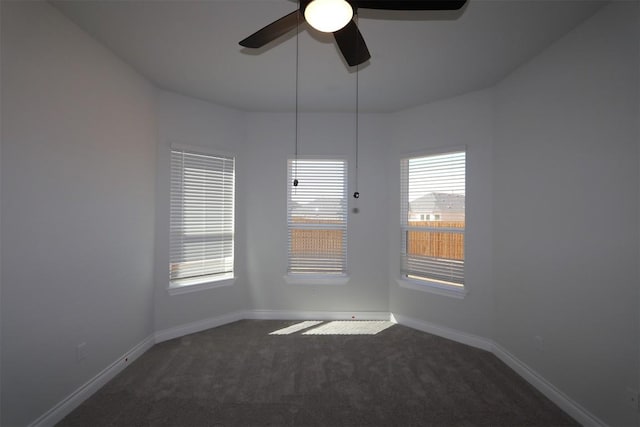 carpeted empty room featuring baseboards and ceiling fan