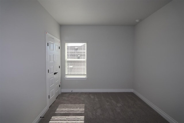 carpeted empty room with baseboards