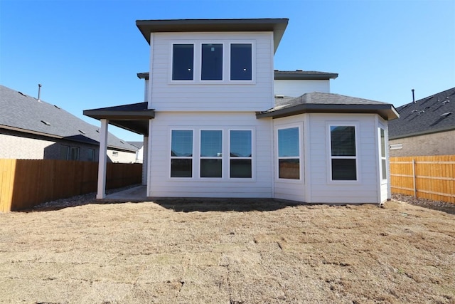 rear view of property with a fenced backyard