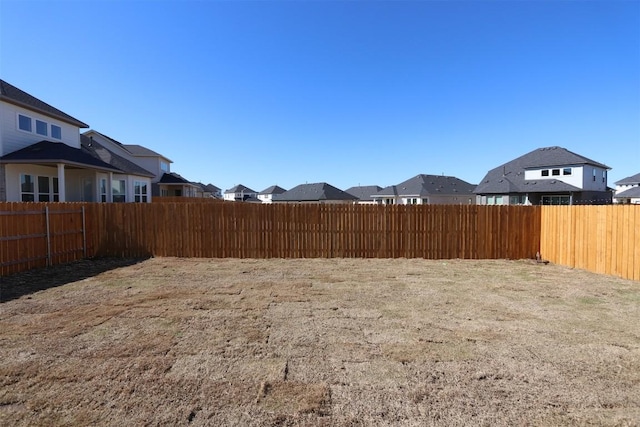 view of yard with a residential view and fence