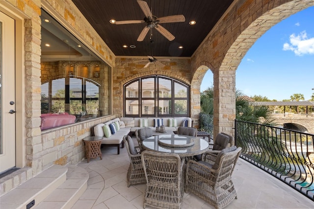 view of patio / terrace with ceiling fan and an outdoor living space