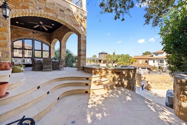 view of patio with outdoor lounge area and ceiling fan