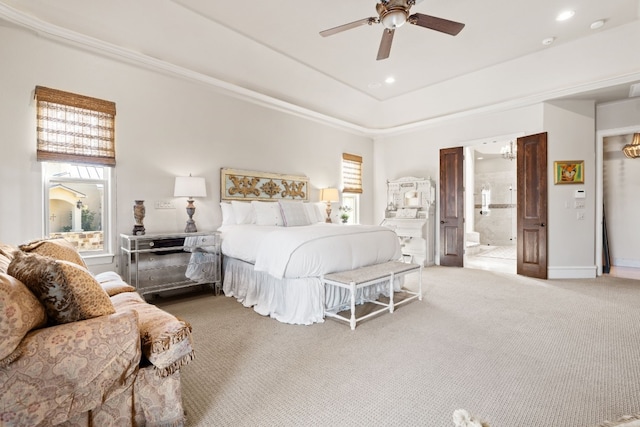 bedroom featuring ceiling fan, carpet floors, ensuite bathroom, and multiple windows