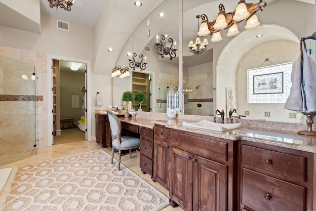 bathroom featuring tile patterned floors, vanity, and tiled shower