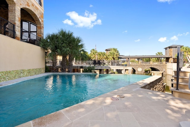 view of swimming pool with a patio area