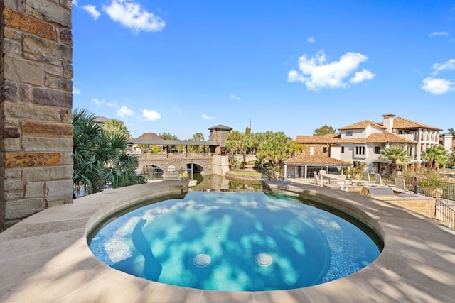 view of pool with a jacuzzi