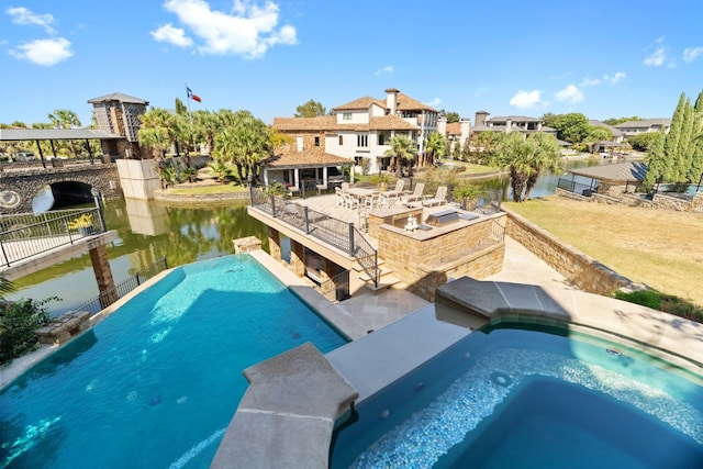 view of pool featuring a water view and a jacuzzi