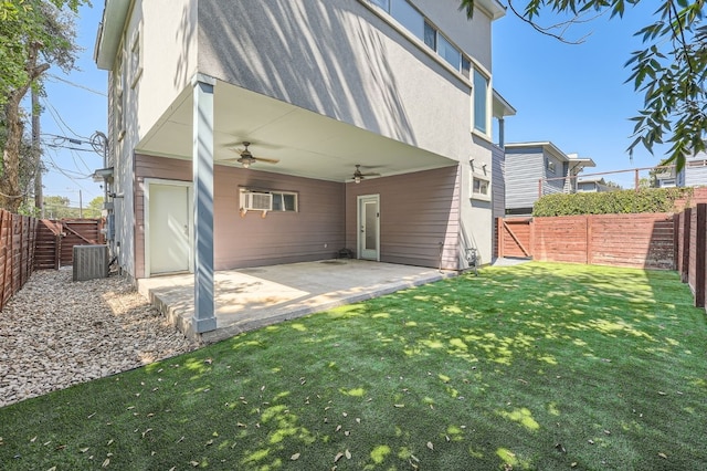 back of house featuring a patio, a lawn, and ceiling fan