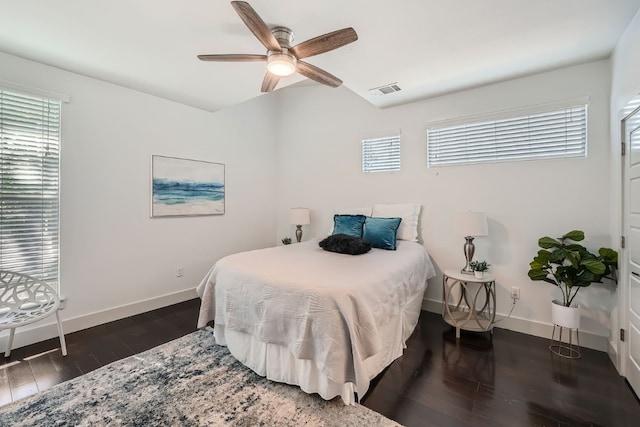 bedroom with dark hardwood / wood-style flooring, multiple windows, and ceiling fan