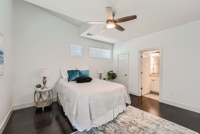 bedroom featuring connected bathroom, dark hardwood / wood-style flooring, and ceiling fan