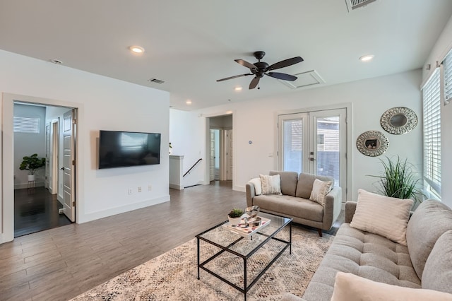 living room with wood-type flooring, ceiling fan, and plenty of natural light