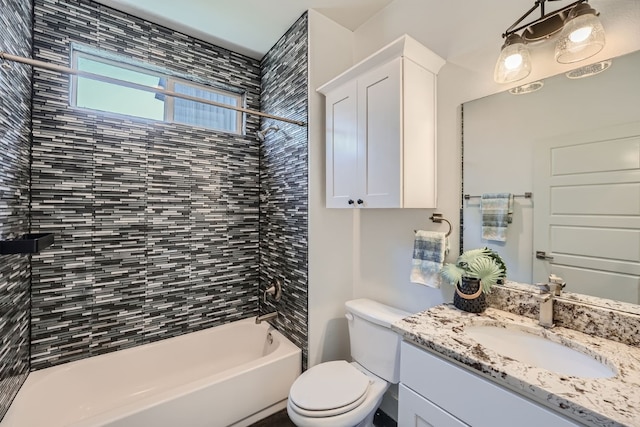 full bathroom featuring vanity, toilet, and tiled shower / bath combo