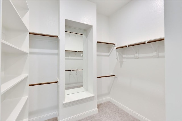 walk in closet featuring carpet