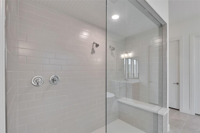 full bath featuring walk in shower and tile patterned flooring