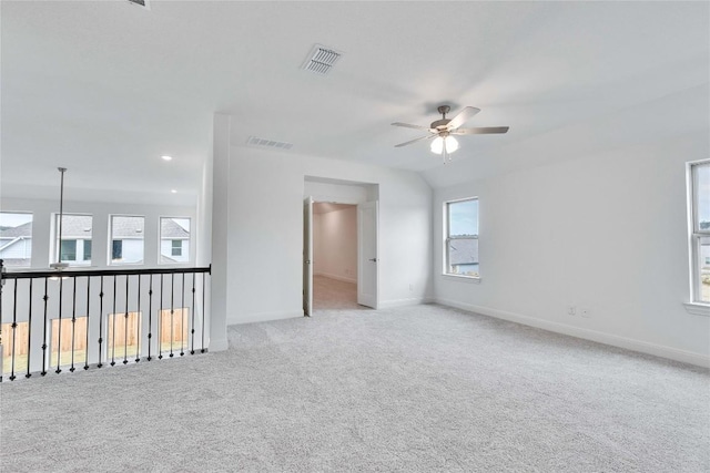 empty room featuring a ceiling fan, carpet flooring, visible vents, and baseboards