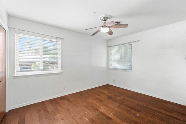 unfurnished room with ceiling fan and dark hardwood / wood-style flooring