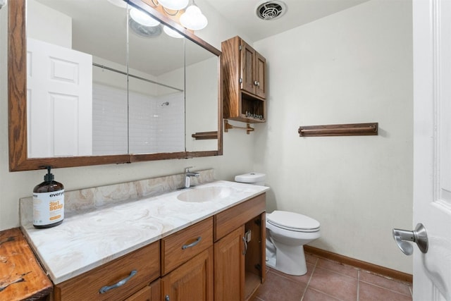 bathroom featuring toilet, vanity, and tile patterned floors