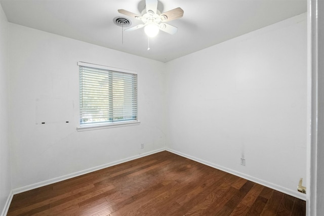 empty room with dark hardwood / wood-style floors and ceiling fan