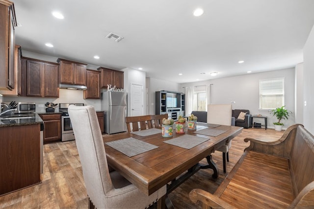 dining area with light hardwood / wood-style flooring and sink