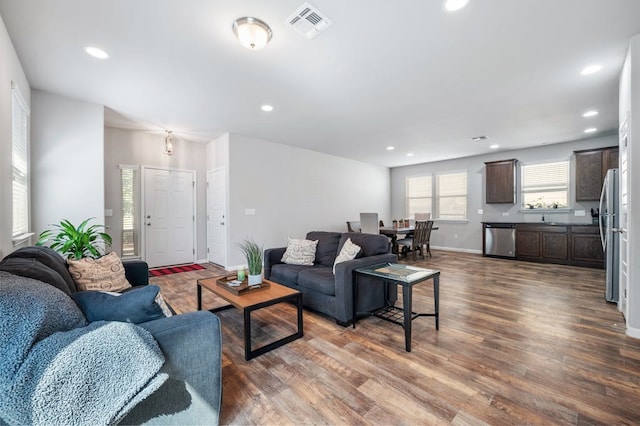 living room with dark wood-type flooring and sink