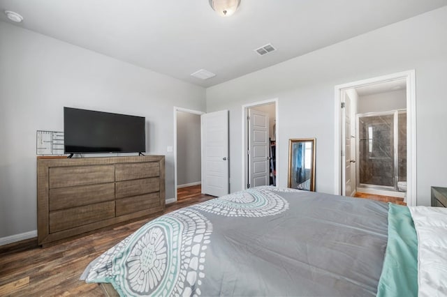 bedroom with a closet, dark hardwood / wood-style floors, ensuite bathroom, and a spacious closet